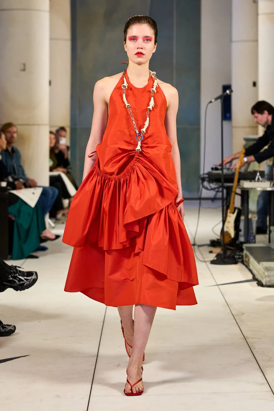 SHOWstudio, Litkovska S/S 27 STRICHA: Model in einem roten Neckholder-Kleid mit Rüschen und langer Kette auf dem Laufsteg